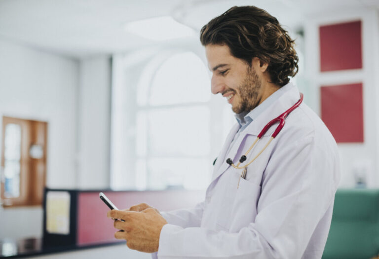 Doctor smiling at phone