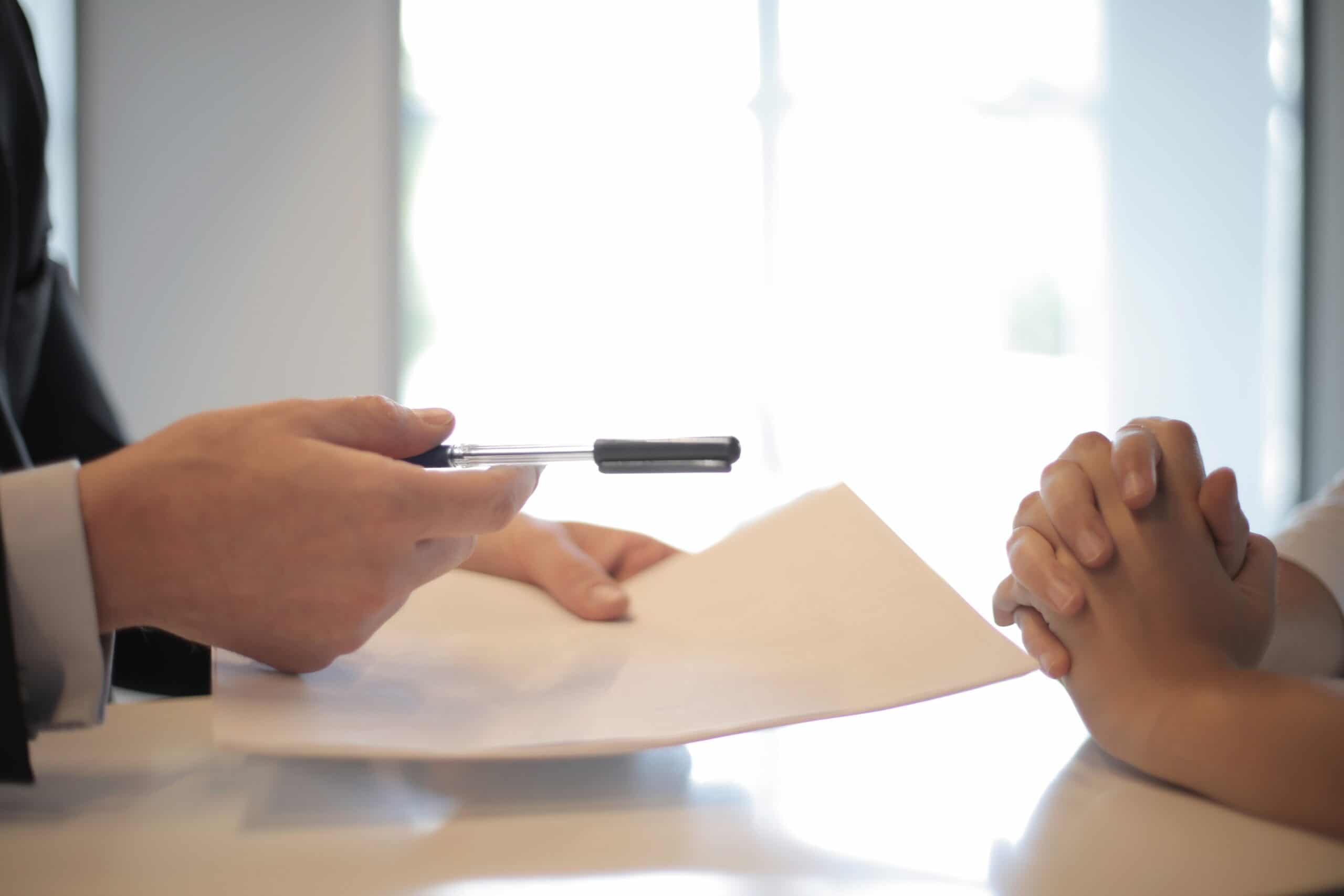 someone handing over a contract to sign