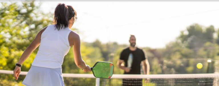 Young woman and man experiencing work life balance by playing pickleball